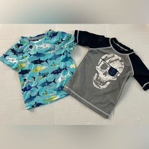 Two boys swim shirt.